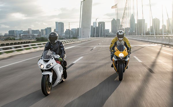 2 motorcycles riding across bridge in the US front-view