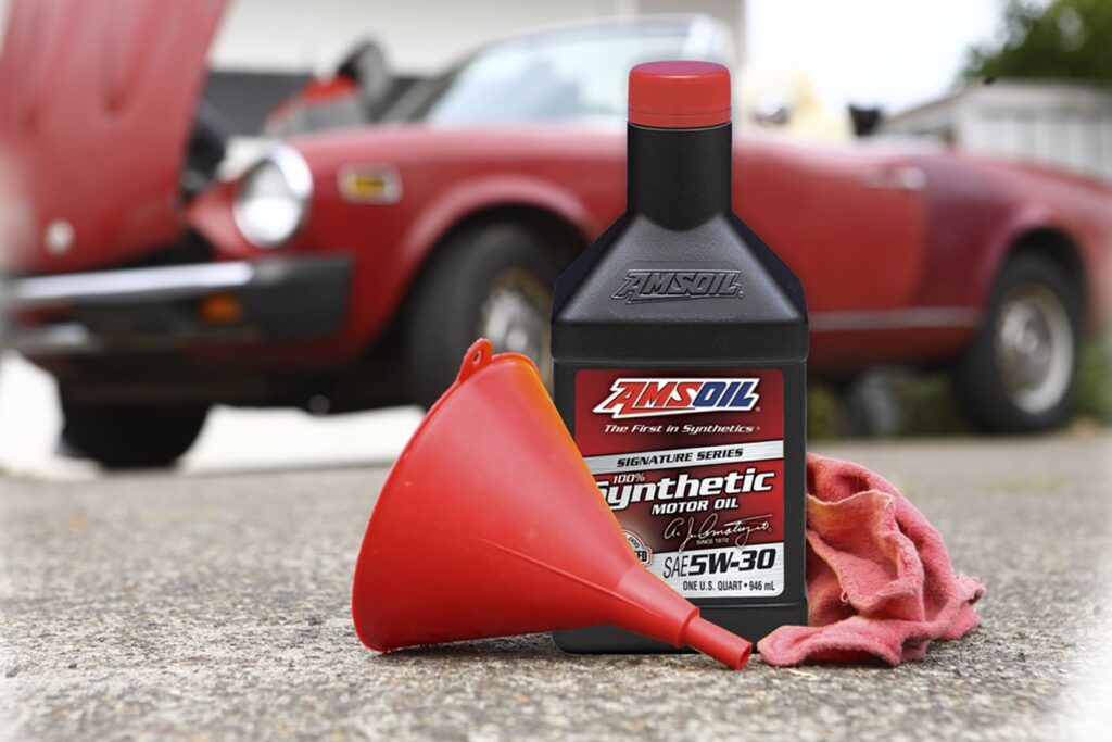 Amsoil synthetic motor oil, funnel and cloth